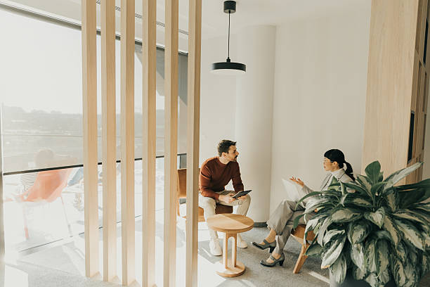 istock Engaging conversation unfolds inside a modern, stylish lounge with natural light filtering through 2206982504