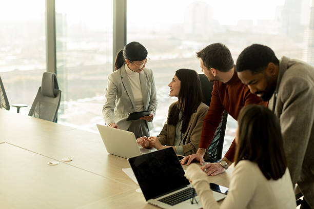 istock Collaboration thrives in a modern office with stylish professionals engaged in discussion 2206982506