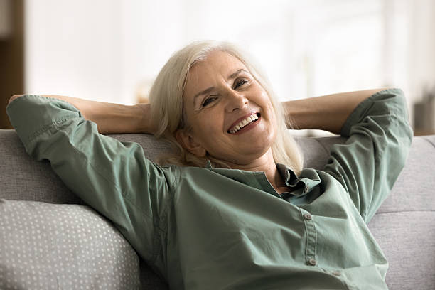 istock Carefree mature female leaned on sofa relaxing at home 2206984498