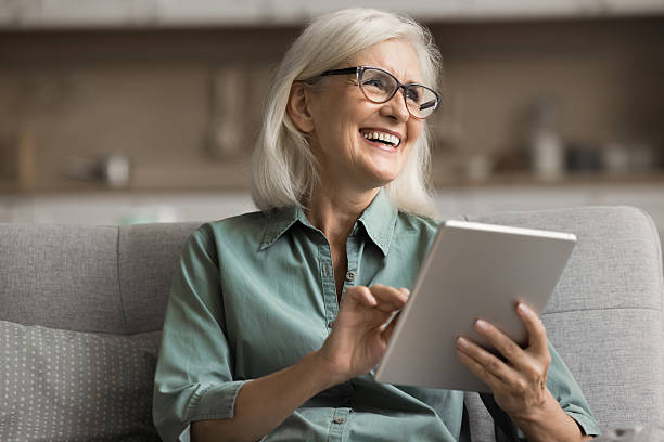 istock Happy mature woman using modern tablet device at home 2206984981