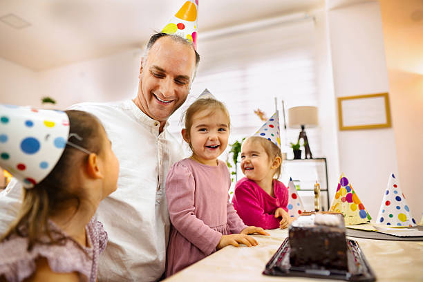istock Father celebrating daughters birthday with chocolate cake at home 2206985173