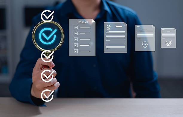 istock User holding magnifying glass, reviewing steps through document, concept of policy and compliance documentation, agreement terms and conditions, validation. 2206985919