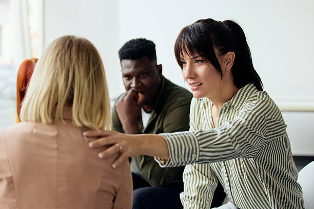 Support Group Discussion With Three Diverse People Engaged in Empathy and Understanding stock photo