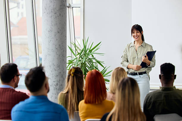 istock Smiling Professional Presenting to a Group in a Bright Modern Office Environment 2206986638