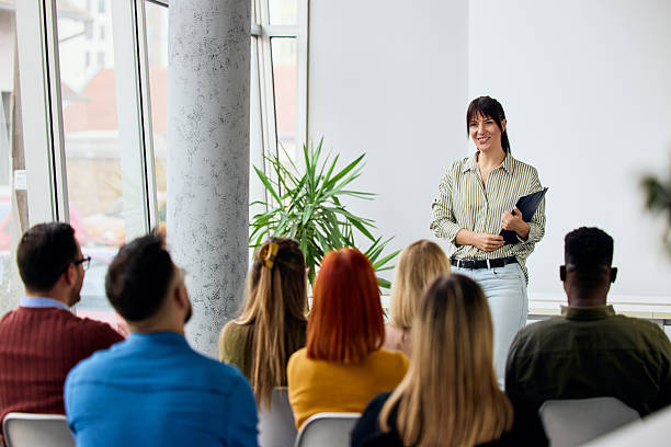 Businesswoman Delivering Presentation to Group in Modern Professional Setting