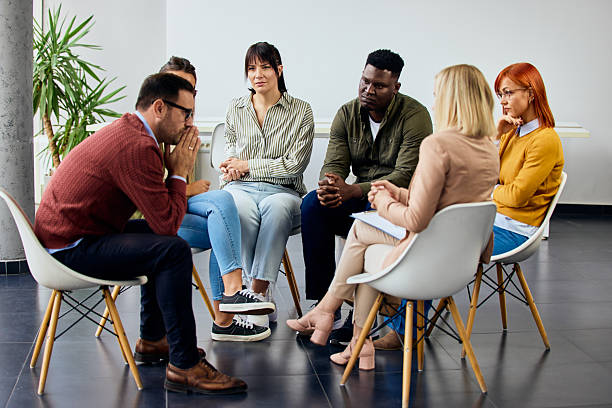 istock Diverse Group in Discussion During a Support Meeting in Modern Space 2206986654