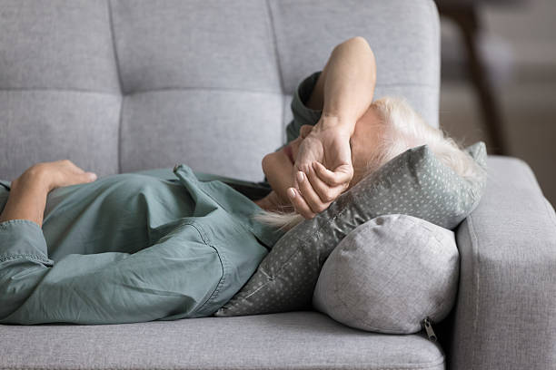 istock Older woman lying on sofa, feeling fatigued, unmotivated, taking rest 2206990424