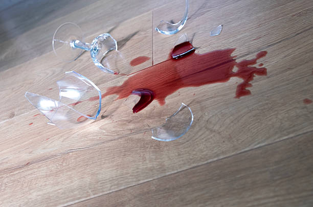 istock Glass from a broken glass on the floor, a stain from red wine. 2206990459