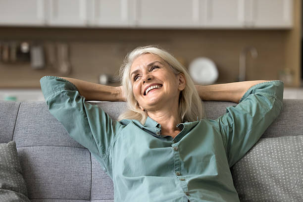 istock Woman resting on cozy couch with smile on her face 2206990722