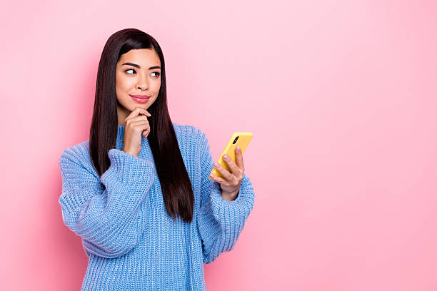 istock Portrait of attractive minded girl using device gadget smm post chat creating solution copy space isolated over pink pastel color background 2206992317