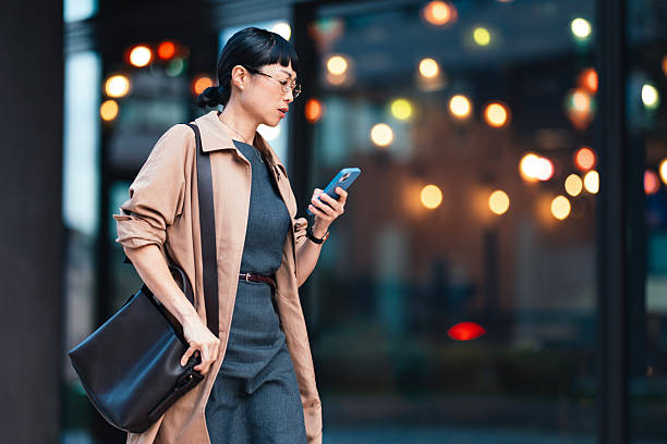 istock Businesswoman Checking Her Smartphone While Walking in an Urban Setting 2206992564