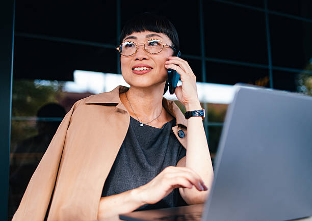 istock Professional Businesswoman Working Outdoors With a Smartphone and Laptop 2206992575