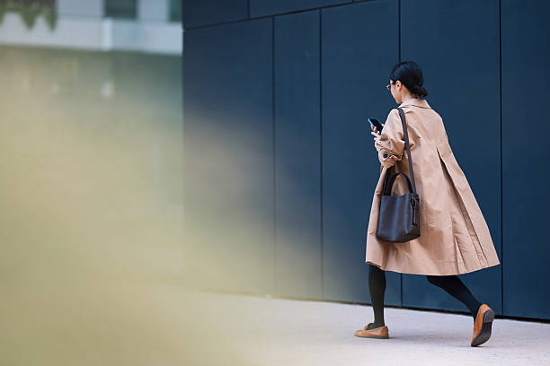istock Businesswoman Walking in the City While Using Her Smartphone 2206992649