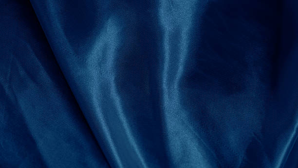 istock Dreamy silk texture in soft blue shades with flowing waves and delicate glow 2206993846