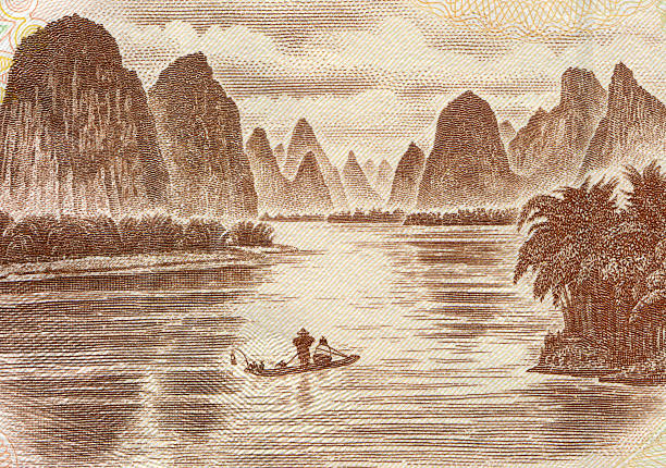 Scenery along the Yulong River near Yangshuo, Guilin in Guangxi Province, China. Bamboo rafts are moored by the river bank near Yangshuo.