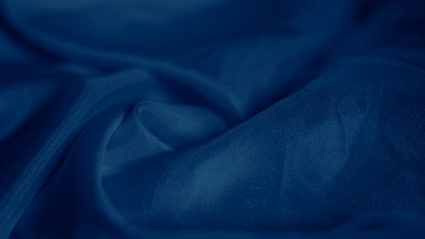 istock Dreamy silk texture in soft blue shades with flowing waves and delicate glow 2206994657