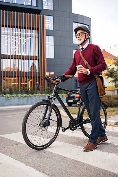 istock Senior Professional With Bicycle and Coffee Near Office Building 2206995254