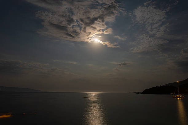 Moon Sparkle Over The Sea in The Summer Night. Landscape with Moonlight Road and Mediterranean Sea