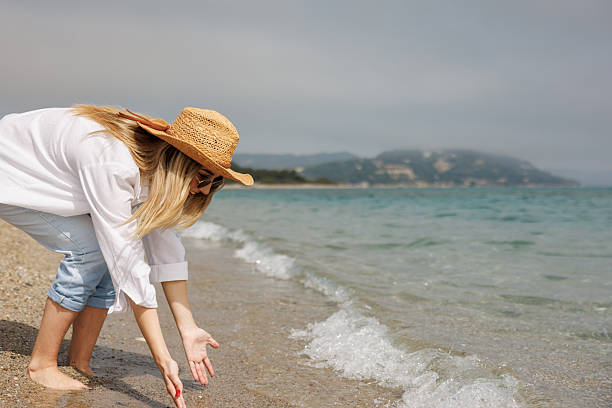 istock Playful woman on the beach 2206995521