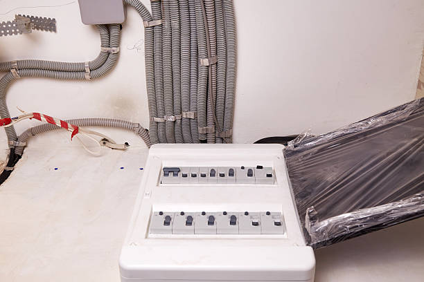 istock Electrical wires in a protective corrugated pipe on the ceiling and a modular housing on the wall 2206996419