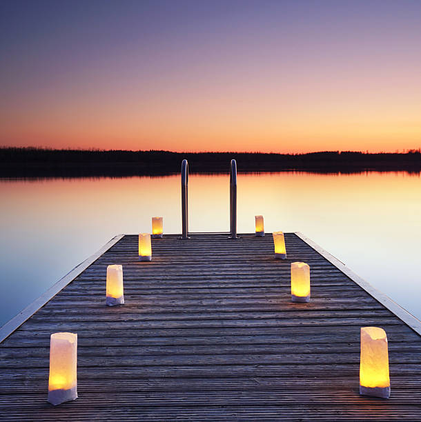 pier with burning candles, romantic place at the beach