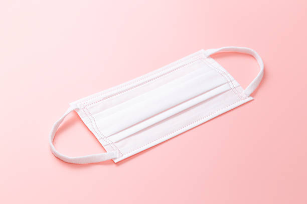 istock Surgical mask on a pink background. 2206999525