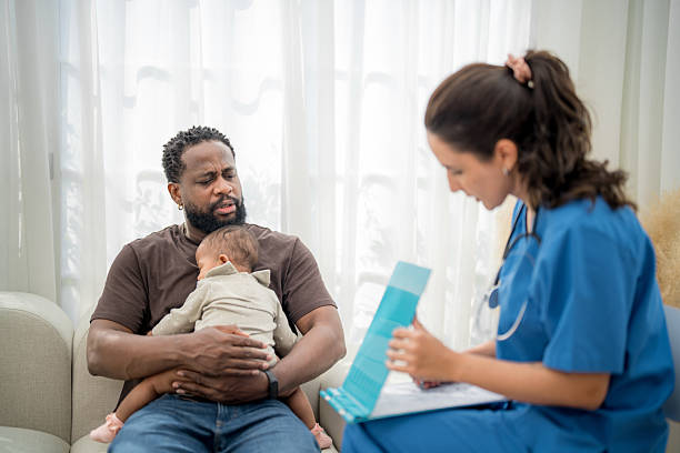 istock Parent consults with pediatrician while holding baby in comfortable clinic setting 2207003693