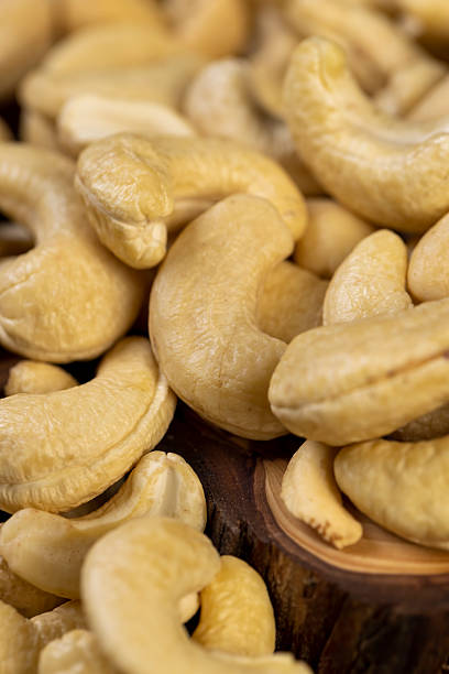 istock large cashew nuts are scattered on a larch board 2207005559