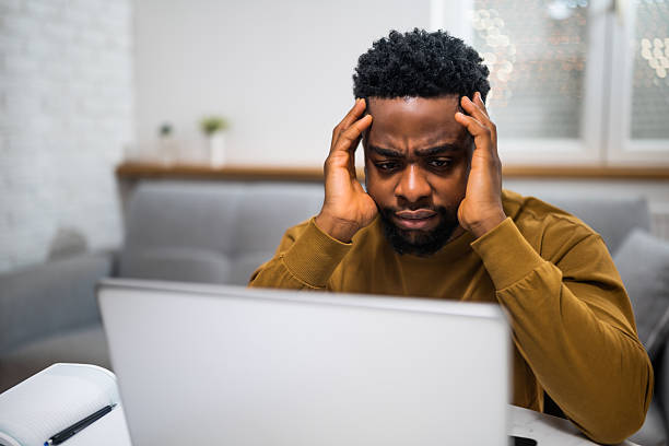 istock Worried  African-American entrepreneur using laptop while working at home 2207008258