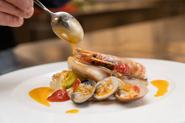 Chef demonstrating prepared risotto with, fish