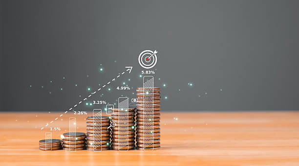 istock Stacks of coins represent financial growth, with digital graphs overlaying the image to indicate progress and investment success. 2207010501