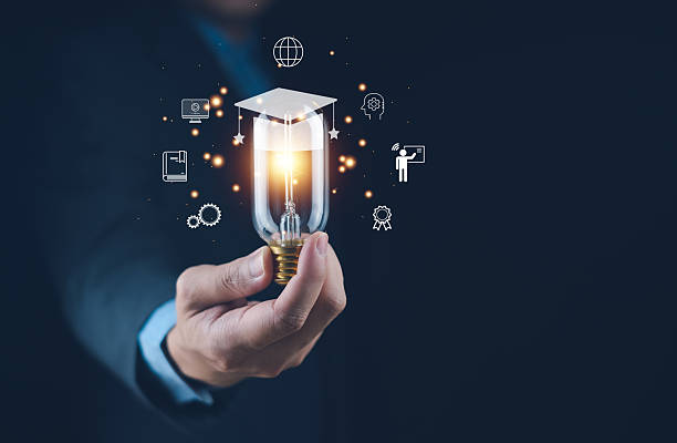 istock A person holding a light bulb with educational icons around it, representing innovation and knowledge. 2207010578