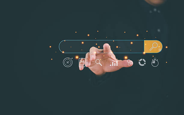 istock A hand reaching toward a search bar, surrounded by icons, symbolizing digital interaction and data exploration. 2207012319