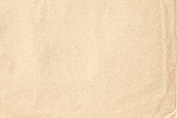 istock Creased brown paper texture material closeup 2207012608