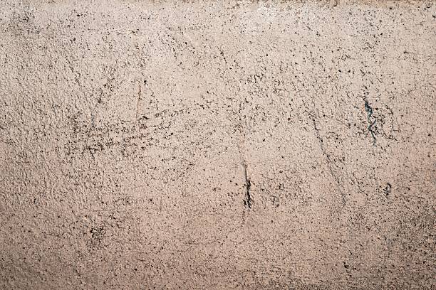 istock Rough beige concrete wall texture with natural speckles, perfect for backgrounds or design backdrops 2207013165