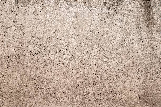 istock Rough beige concrete wall texture with natural speckles, perfect for backgrounds or design backdrops 2207013243