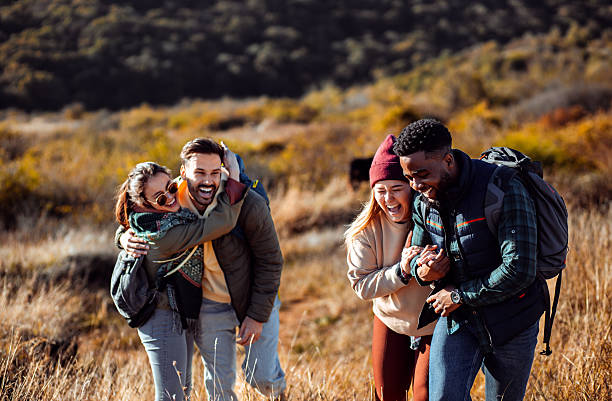istock Smiling group of friends having fun while hiking together on hill. 2207013840