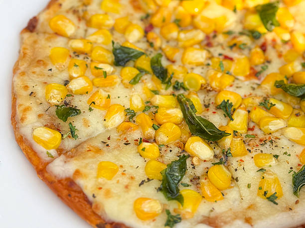 Image of sliced sweetcorn pizza, olives, mozzarella cheese /  Italian food, fresh ingredients, crispy crust, mediterranean culinary experience