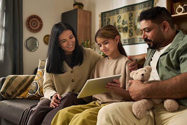 istock Family Enjoying Quality Time on Sofa Together 2207014209