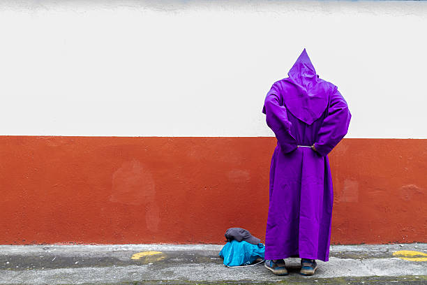 Antigua Guatemala, Sacatepequez, Guatemala. March 10, 2024. Men dressed in purple robes during the Semana Santa Holy Week Easter procession.