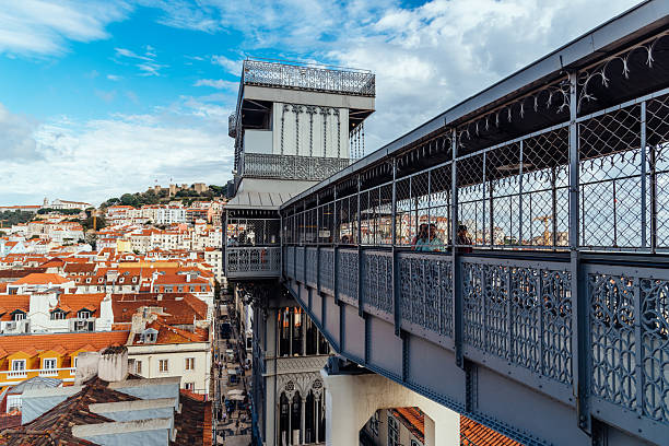 Admire Lisbon Santa Justa Lift and enjoy the view of the city's red rooftops. Lisbon, Portugal - 29 October, 2022: The Santa Justa Lift offers panoramic views of the city, connecting lower streets with Carmo Square in Lisbon, Portugal. santa justa lift portugal stock pictures, royalty-free photos & images