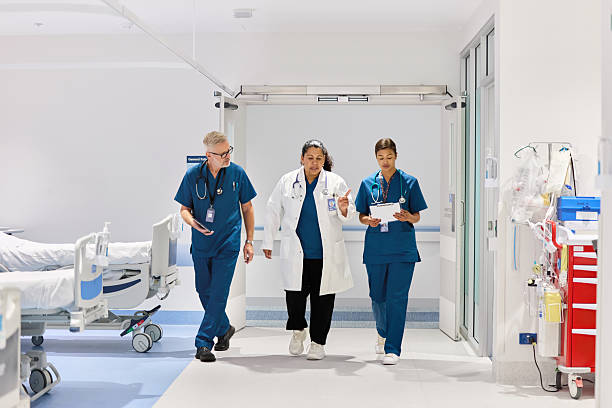 istock Doctor and nurses walking through hospital hallway 2207015553