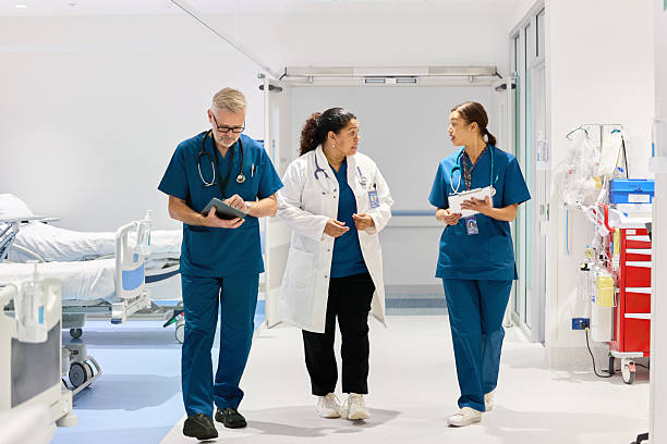 istock Doctor and nurses discussing in hospital hallway 2207017528