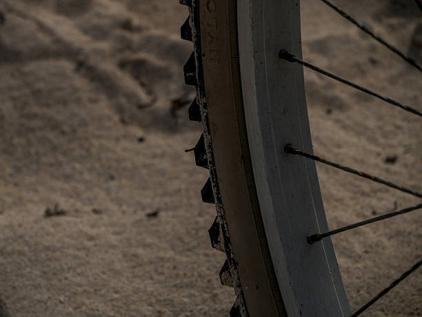 istock bicycle tire detail on sand background 2207017983
