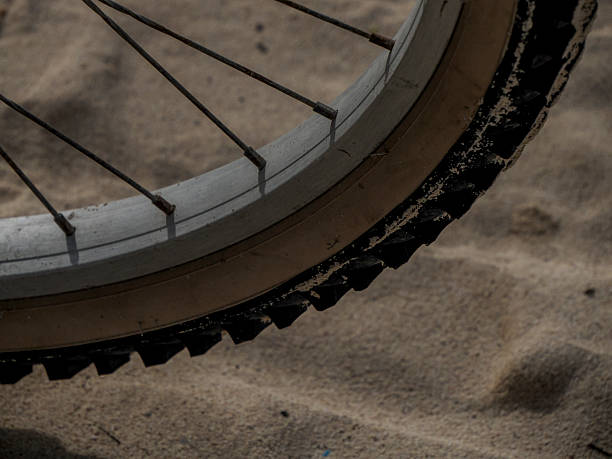A bicycle tire detail on sand background