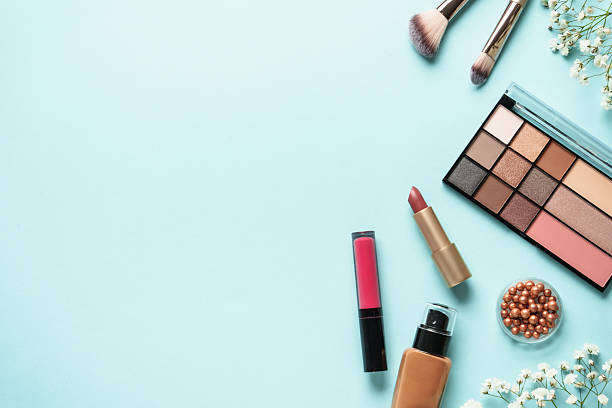 istock Make up products on blue with flowers. 2207018173