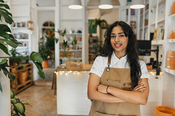 istock Indoor Plant Store with Staff Member Smiling Cheerfully 2207018446