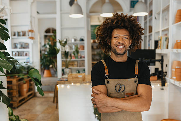 Young Man in a Plant Shop Boasting a Bright Smile