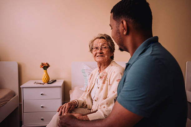 istock Volunteer talking to elderly people 2207018954