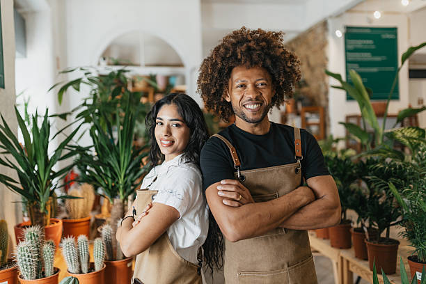 istock Stylish couple posing confidently in plant store. 2207019213